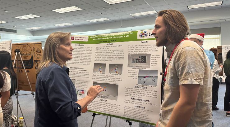 Engineering student explaining their research during the research symposium. 