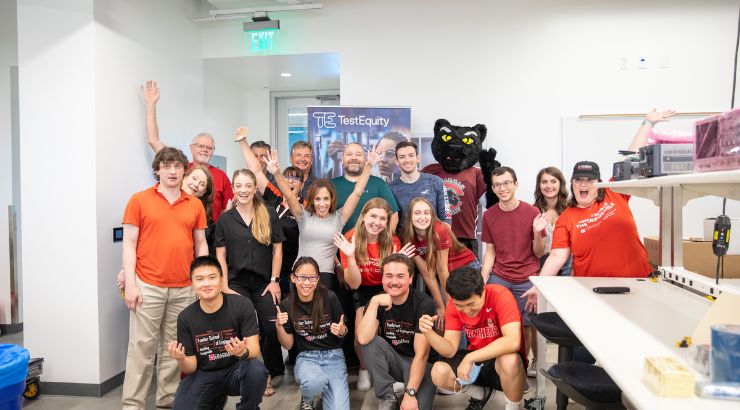 A group of students, faculty, and staff pose for a group photo.