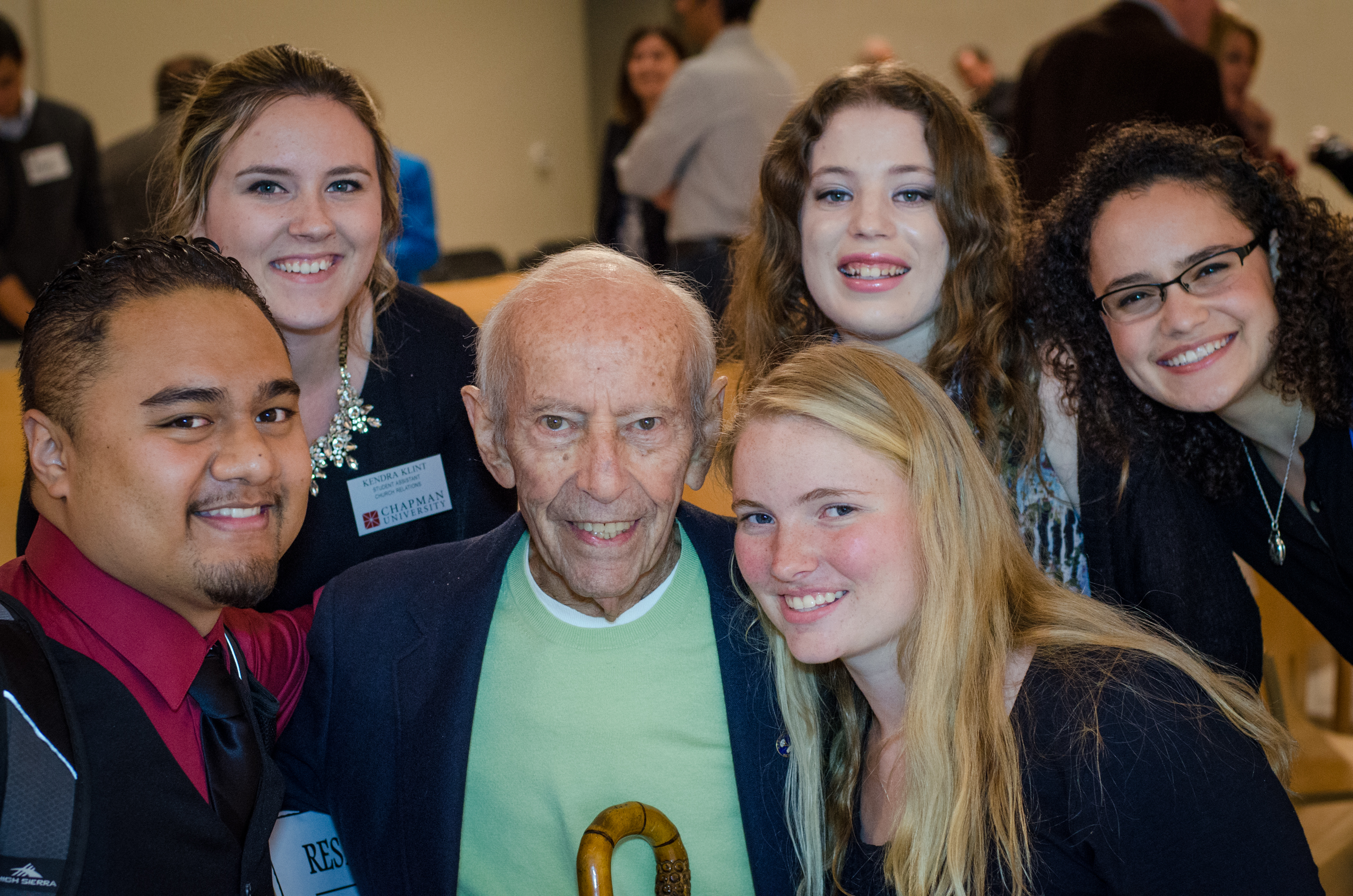 Curt Lowens surrounded by Chapman University Students