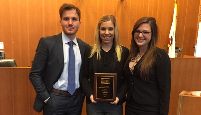 Student holding awards at national moot court
