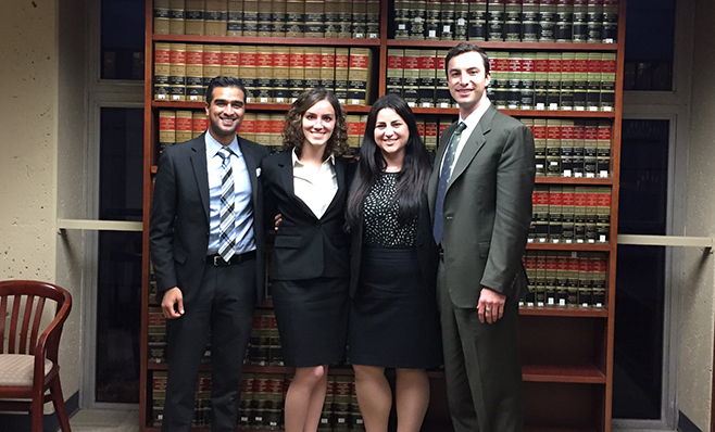 law students in front of bookshelf
