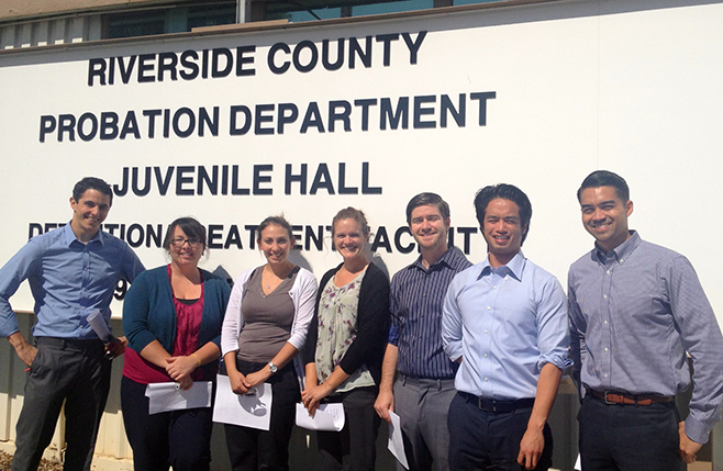 Law student in front of Juvenile Mediation Clinic