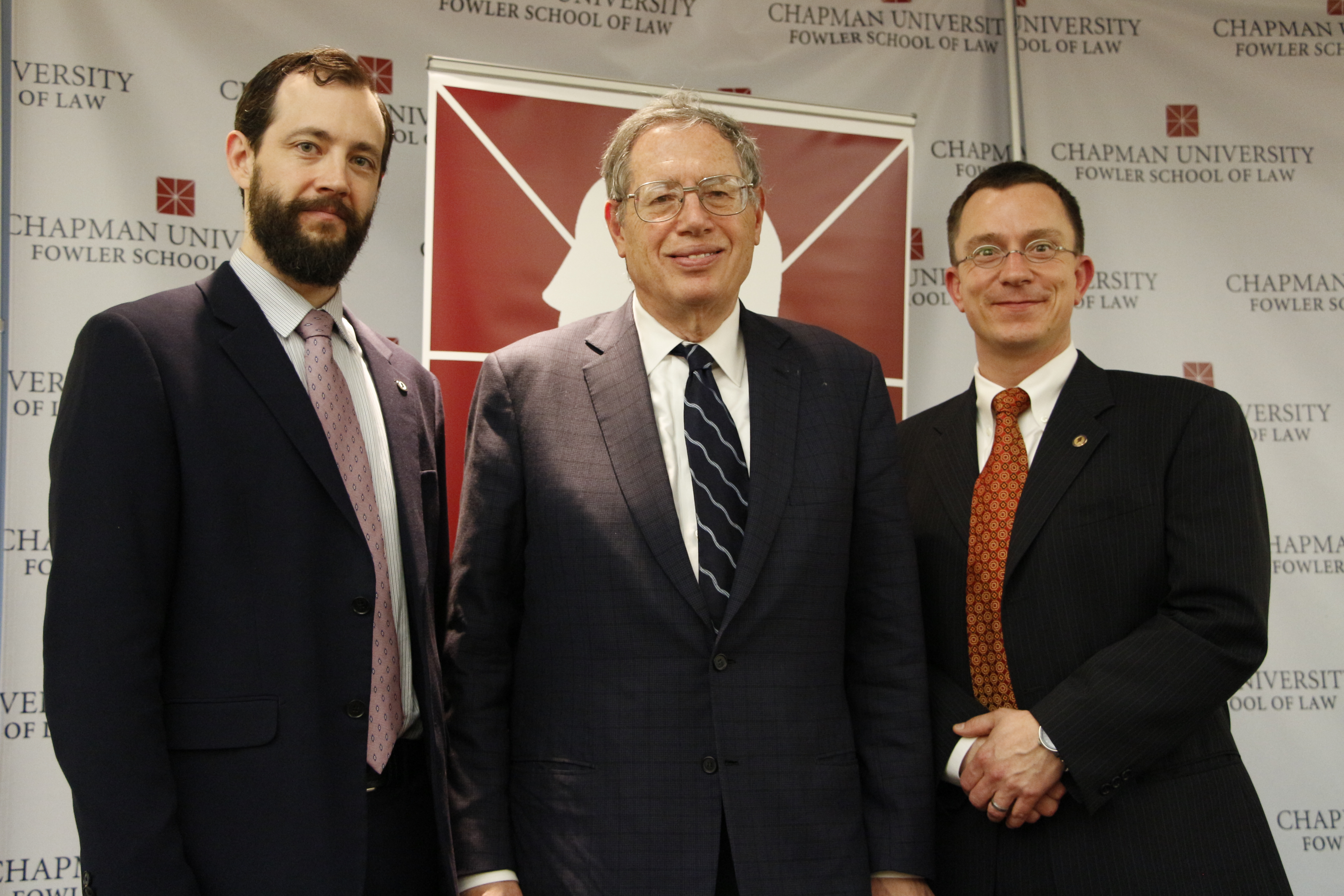 NYU School of Law Professor posing with others
