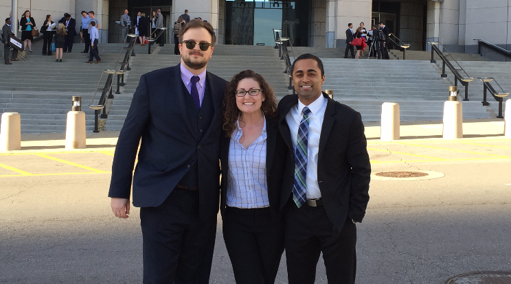 student posing outside courthouse