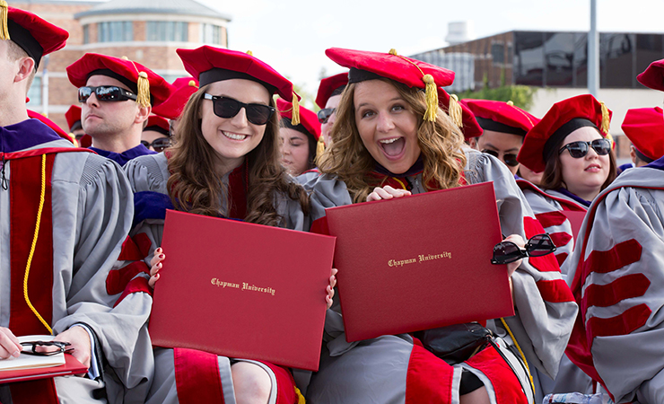 2016 graduates hold up diplomas