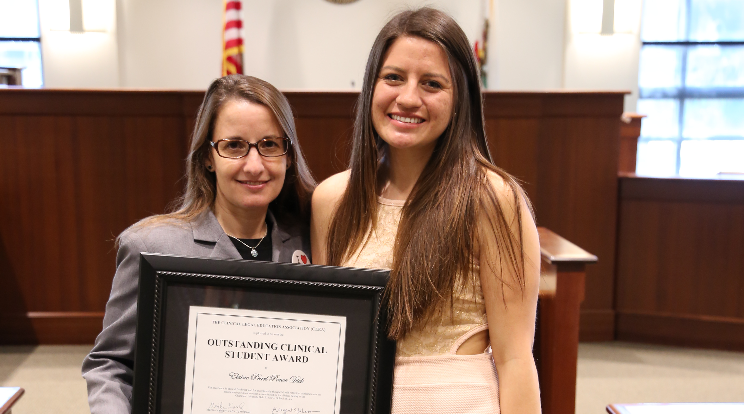 CLEA award winner with professor in courtroom