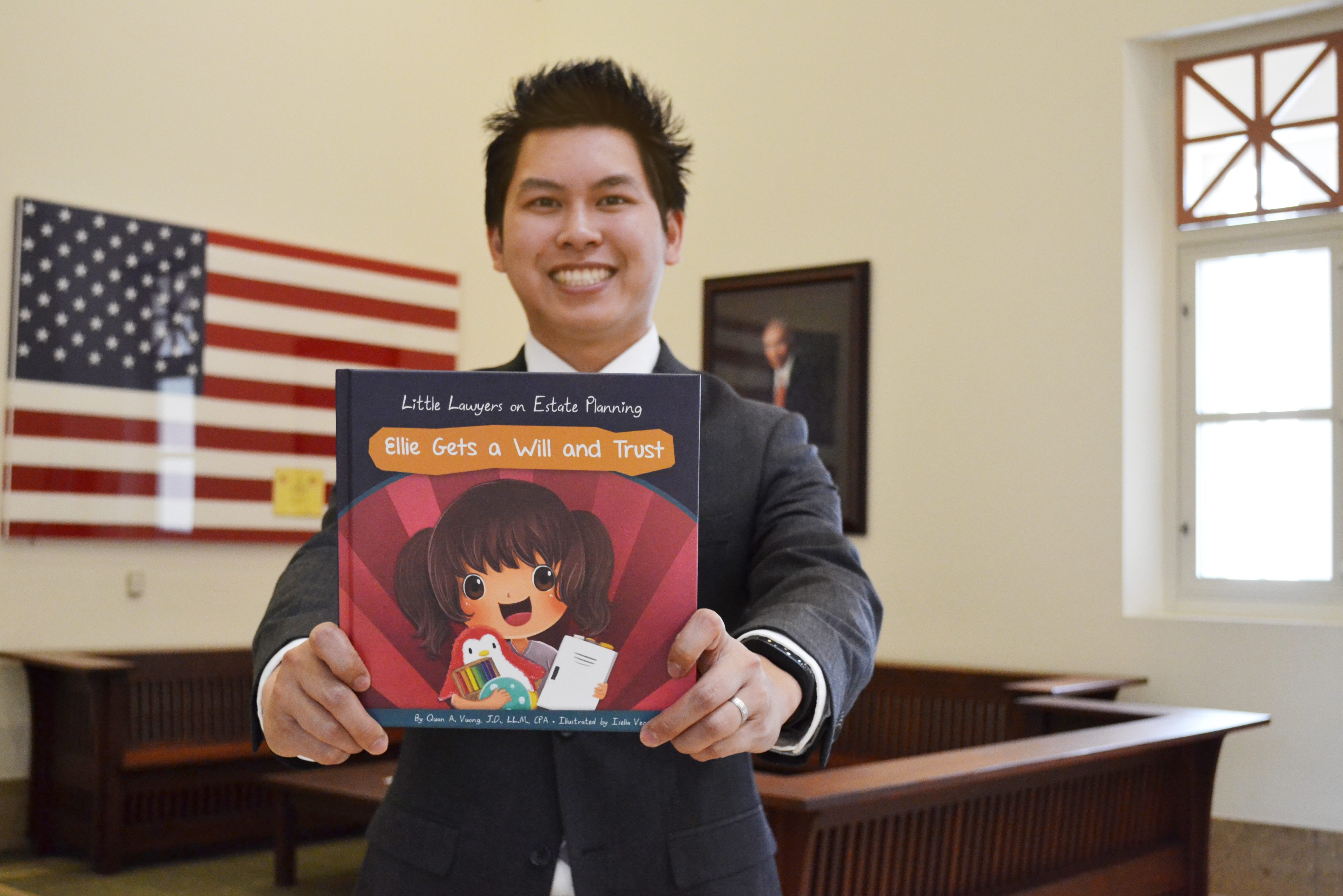 Quan Vuong holds out book