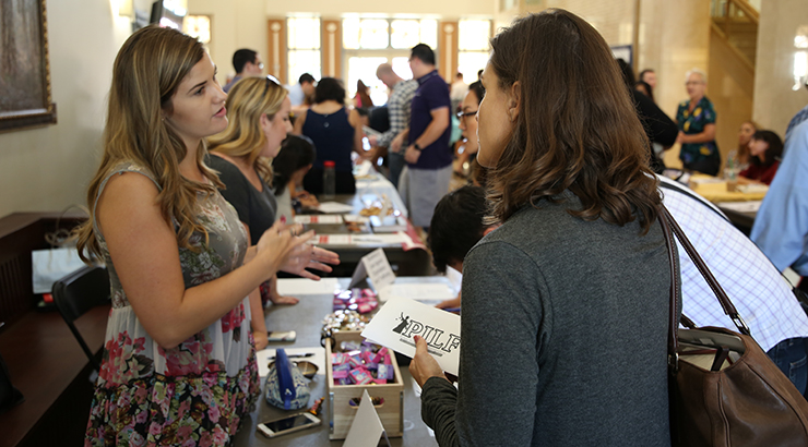 students discuss student a student organization in the lobby