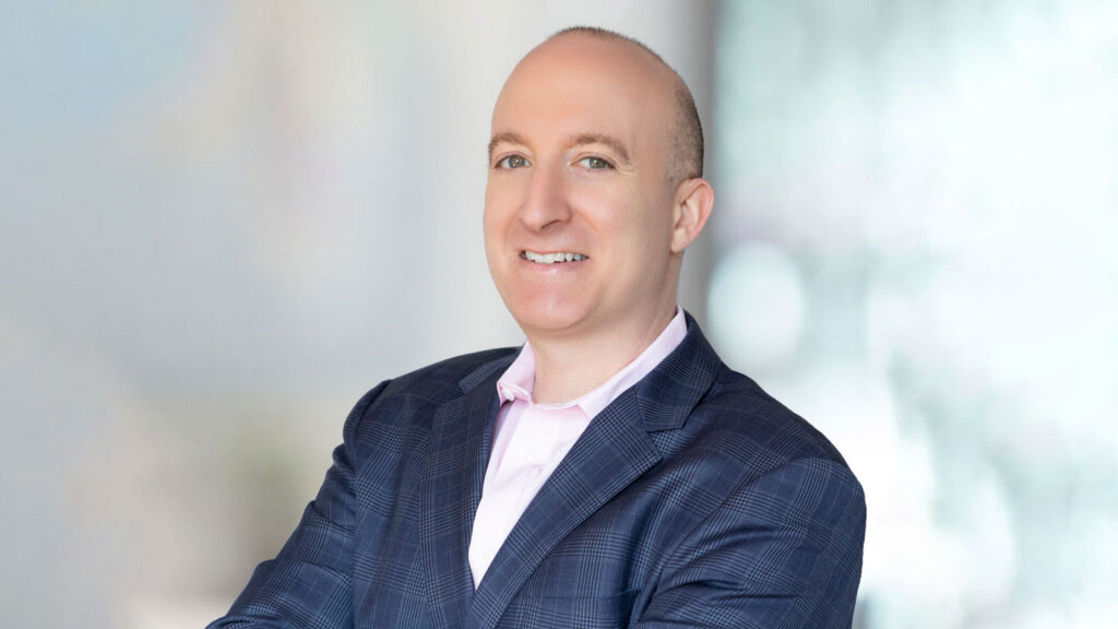 Bald man posing in a blue suit