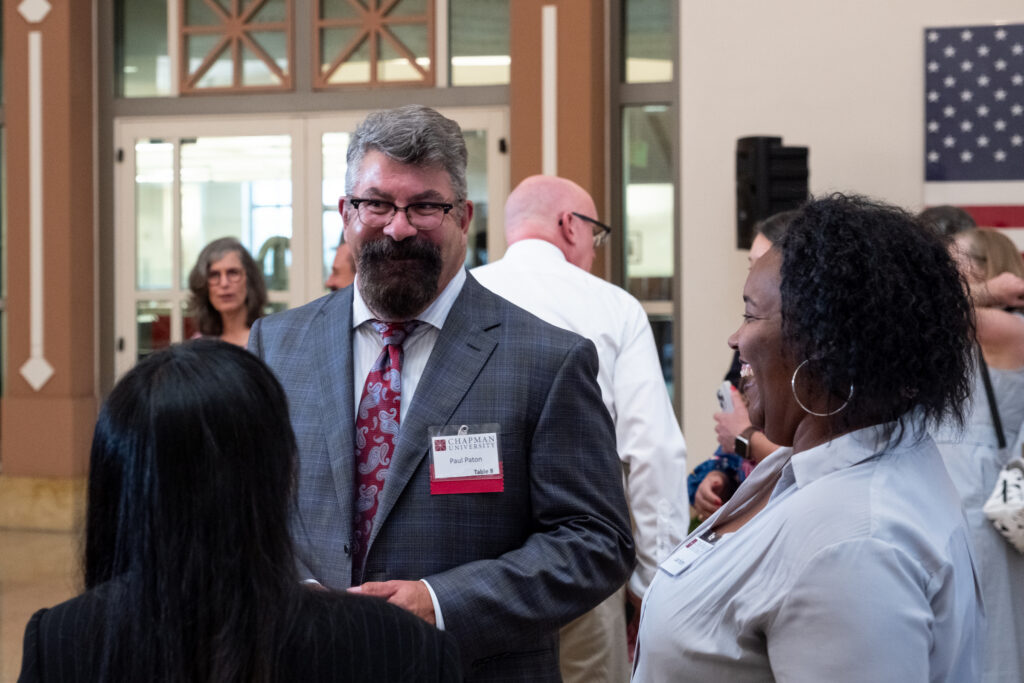 Photo of Dean Paul D. Paton, KC speaking with guests at the reception.