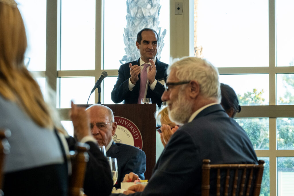 Photo of Executive VP Matt Parlow initiating a round of applause in thanks to Parker S. Kennedy's generous gift to the Law School.
