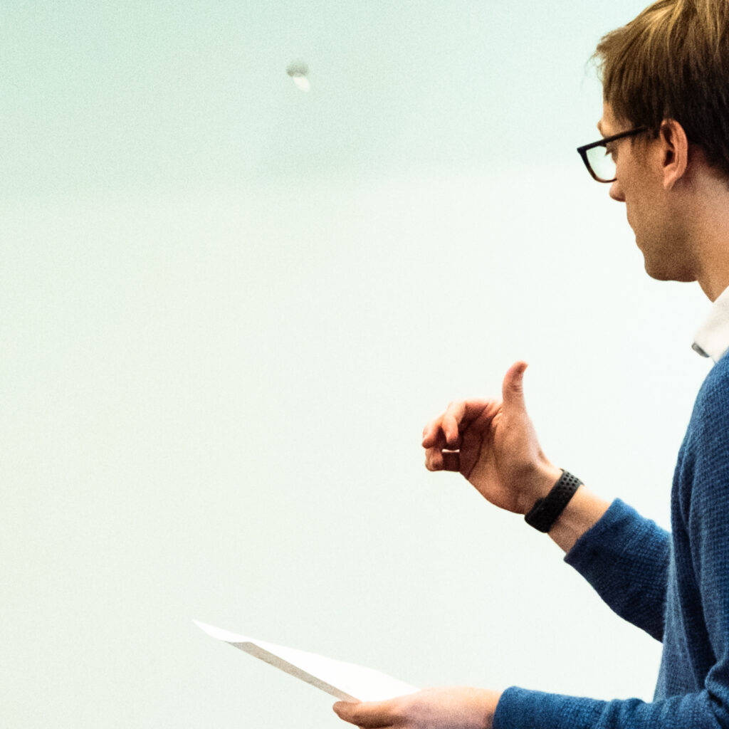 Photgraph of Professor John Bishop tossing a coin.