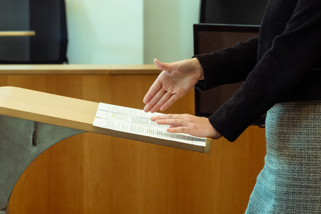 Photograph of contestants presenting their cases to the judges