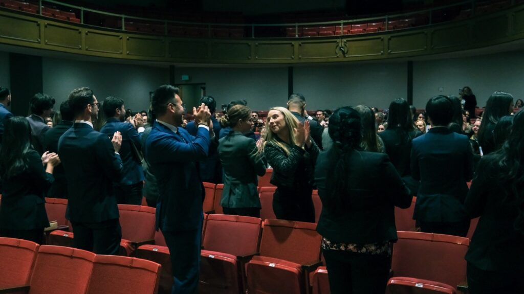 Fowler School of Law graduates applauding their family and others who supported them during their studies