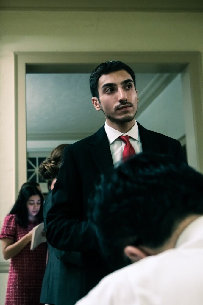 A Chapman Law graduate smiles waiting for Judge Vu's signature