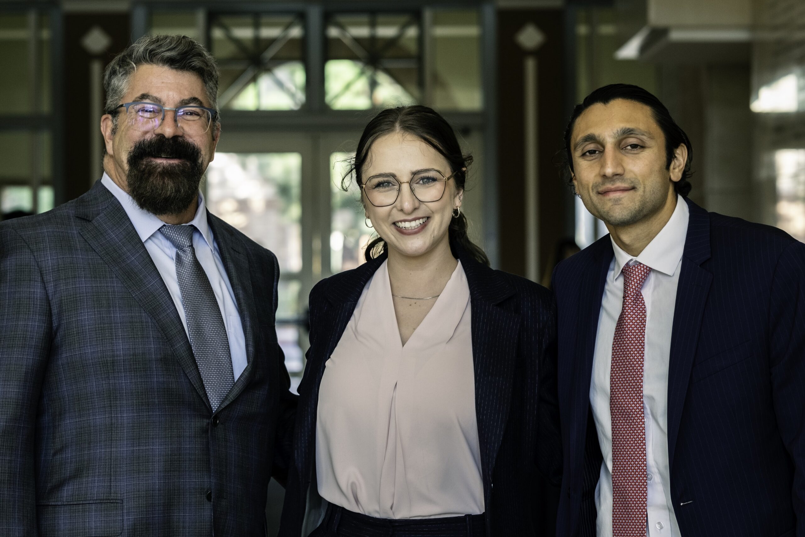 Photograph of Fowler School of Law Dean Paton with Chapman Law Review Editors Bennet Cinkle and Darian Nourian, at the 2024 Chapman Law Review Symposium