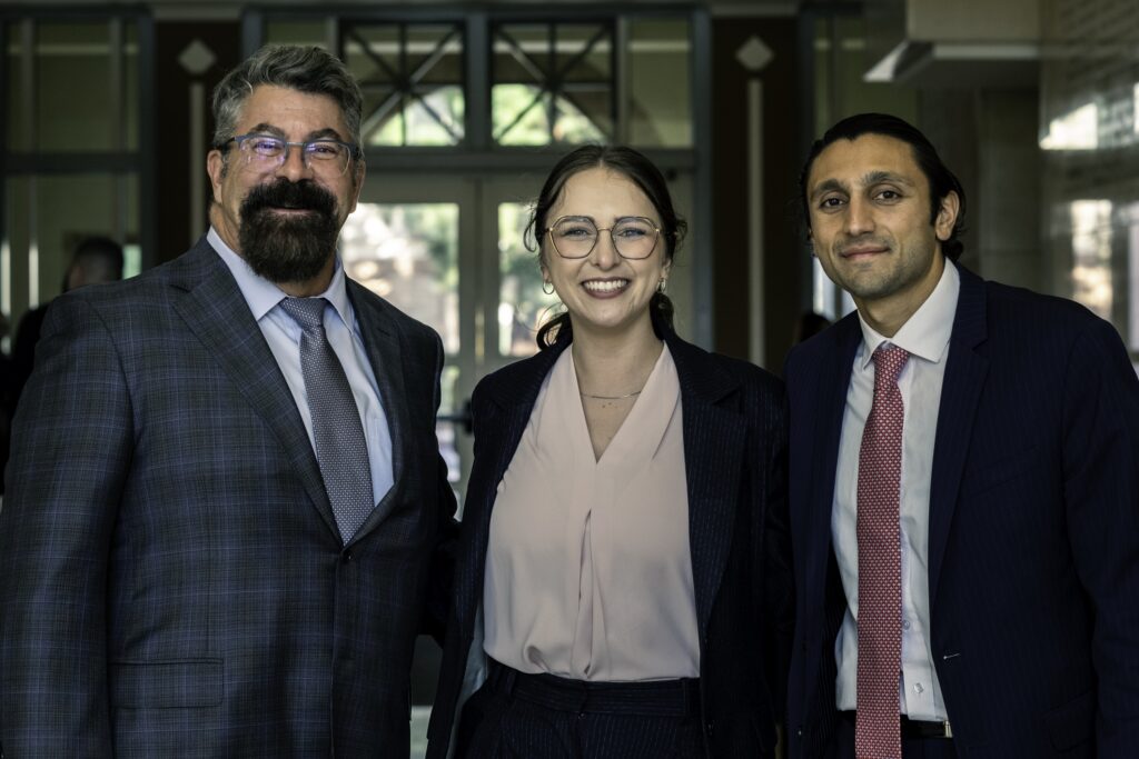 Photograph of Dean Paul Paton with event organizers Bennet Cinkle and Darian Nourian, at the 2024 Chapman Law Review Symposium