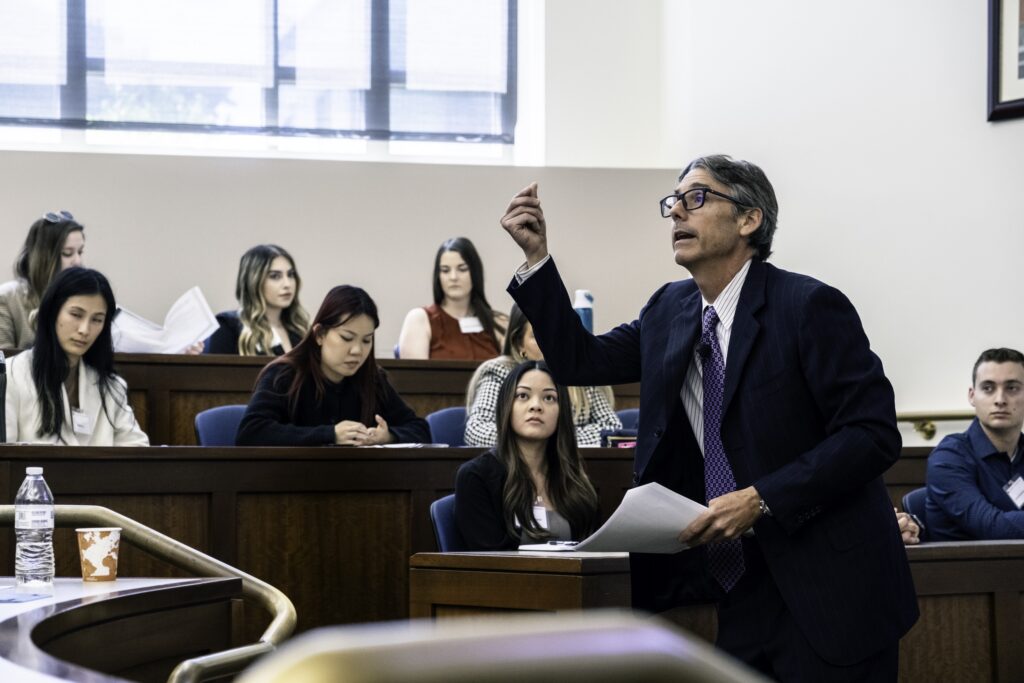 Photograph of a Chapman professor presenting a mock law class at Scholars Weekend