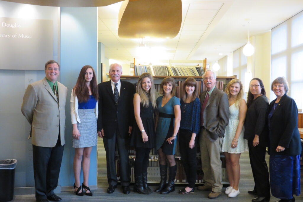 Group of people posing in library.