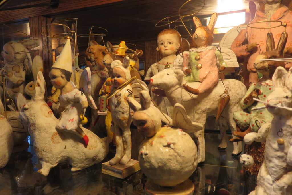 A collection of papier-mache angel figurines on a shelf.