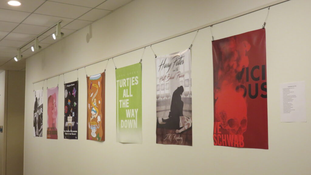 Posters hanging on a wall.