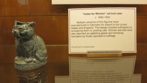 A small cat statue displayed next to explanatory text