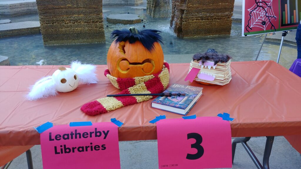 Three decorated pumpkins sitting on a table