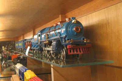 Blue toy train engine on a display shelf