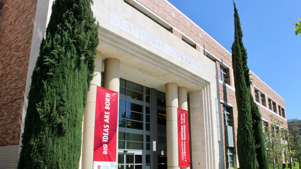 Exterior photograph of the Leatherby Libraries, taken from a low angle on the Wells Fargo stage outside the front of the library