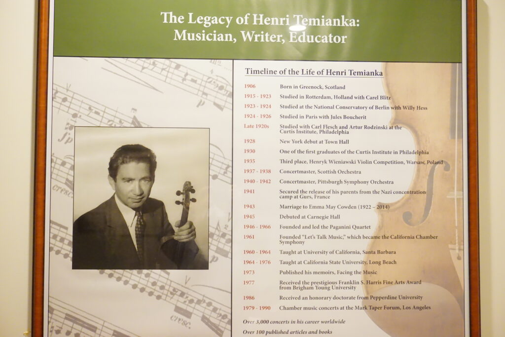 A framed poster with a picture of Henri Temianka and a timeline of his life.