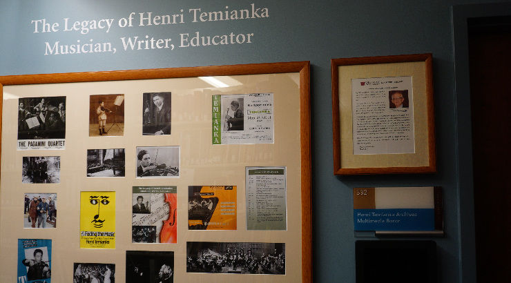 A framed collage on a blue wall under white vinyl lettering that reads, "The Legacy of Henri Temianka Musician, Writer, Educator"