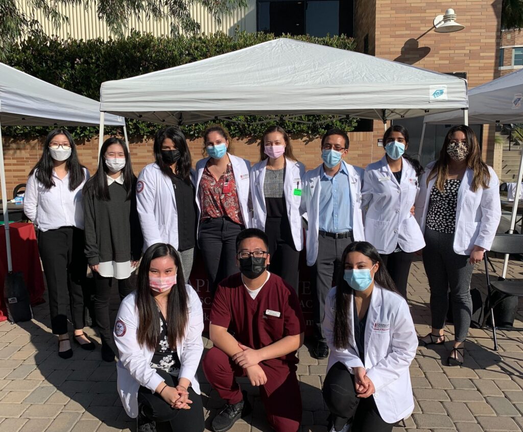 CUSP alumni and students at the health fair booth