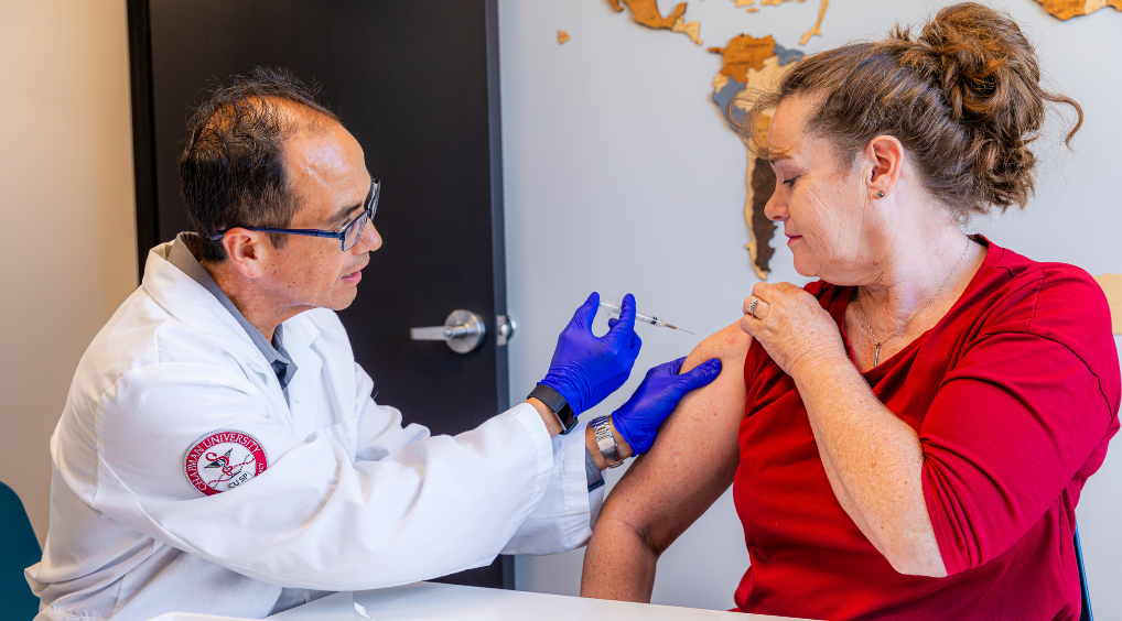 A pharmacist administering a vaccine to a patient