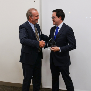Dean Ostrom shaking hands with Dustin Le
