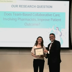 Kayla receiving a certificate from Dr. Taheri