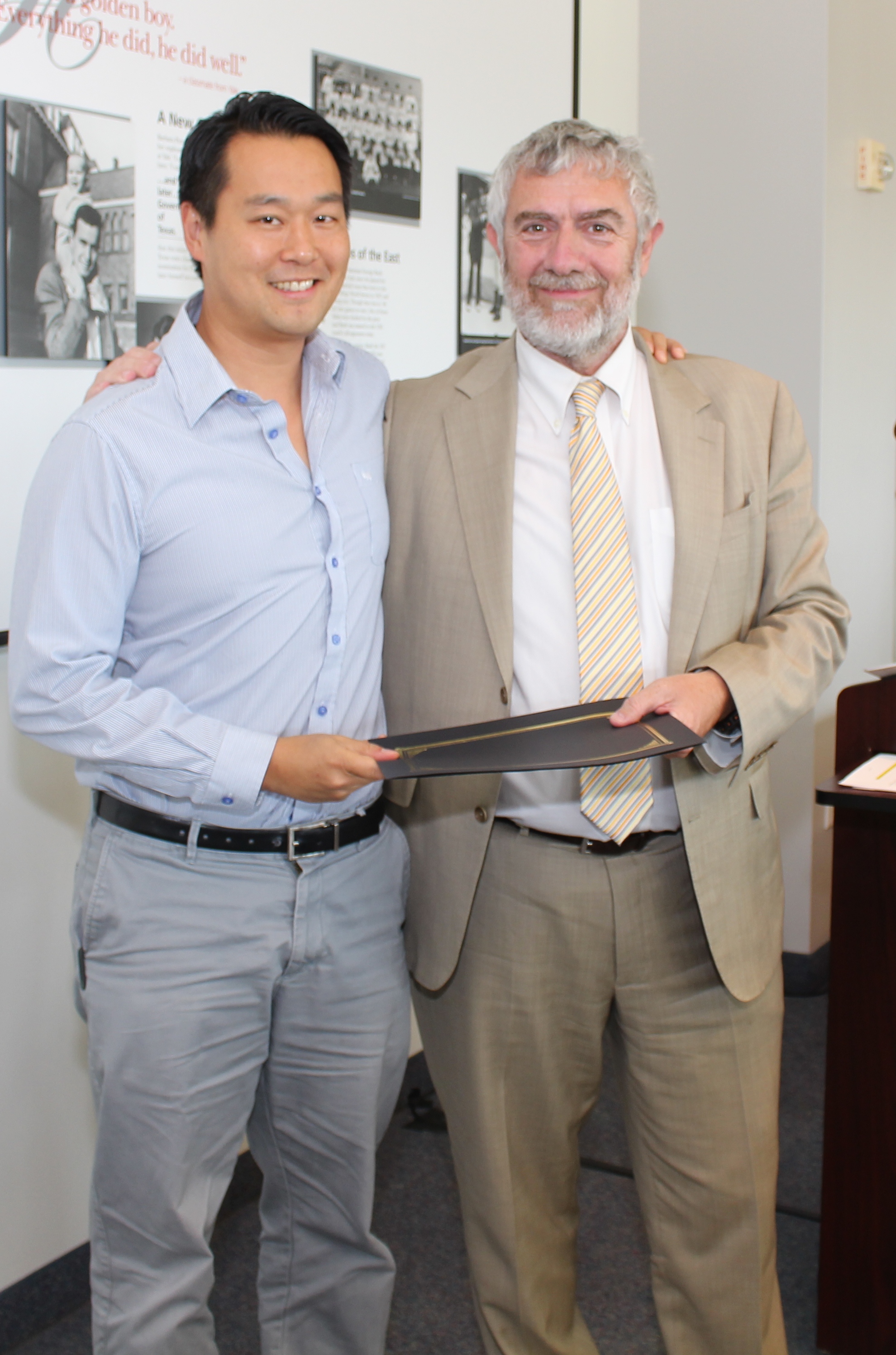 Chancellor Daniele Struppa presents the Senior Wang-Fradkin Professorship to Christopher Kim, Ph.D.