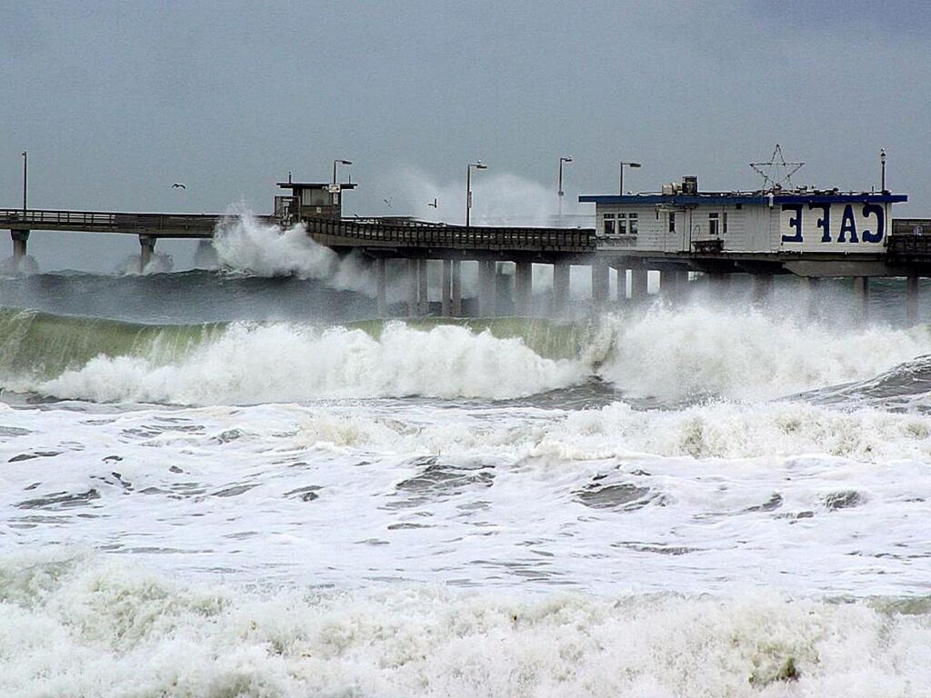 A pier being hit with crushing waves