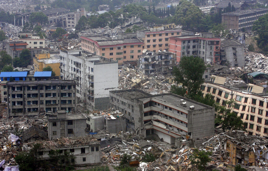 An aerial view shows the earthquake-hit area of Yingxiu town in Wenchuan county, Sichuan province, May 24, 2008. Chinese Premier Wen Jiabao said that the death toll from the massive earthquake on May 12 had passed 60,000 and could reach 80,000 or more. REUTERS/Nicky Loh (CHINA)