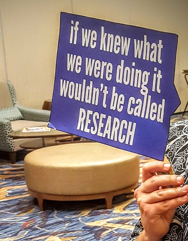 sign that reads "if we knew what we were doing it wouldn't be called research."