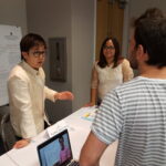 Peter Esperanza (left in white) and Cris Toto right in white) explain their work.