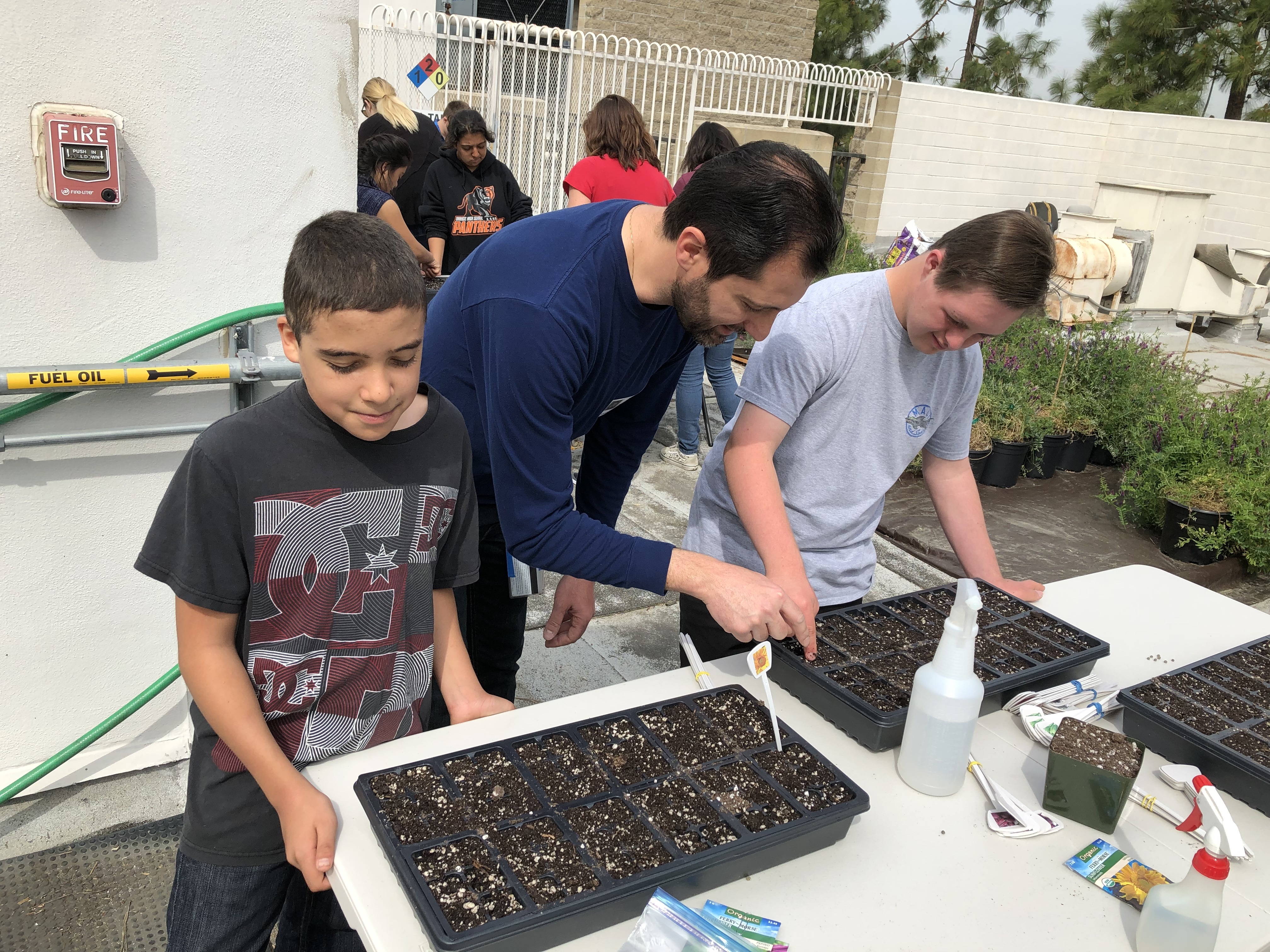 Dr. Atamian shows students how to plant seeds.