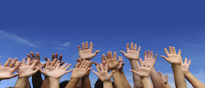 Hands against blue sky