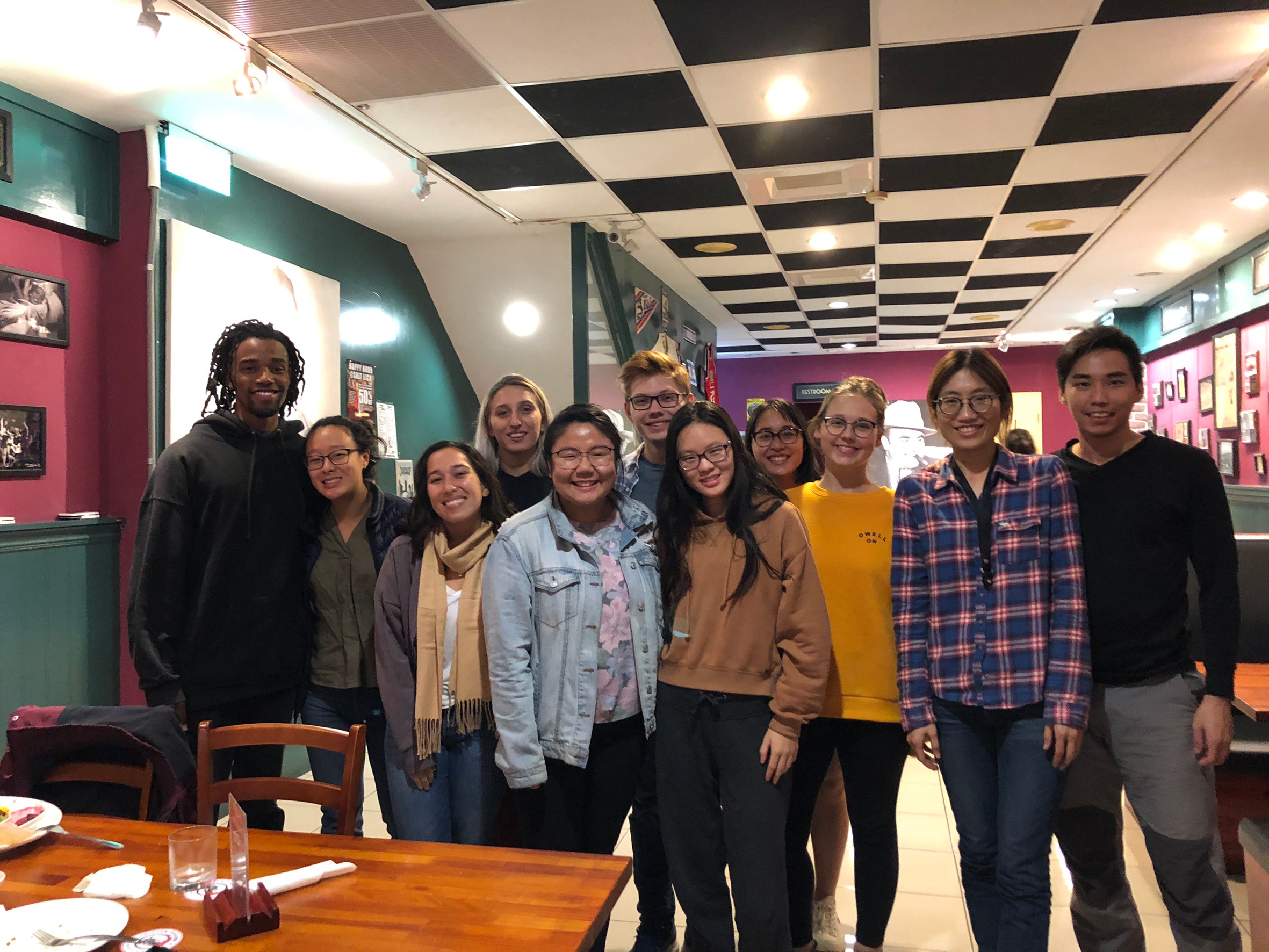 Sun and ten others pose for photo inside restaurant on Thanksgiving
