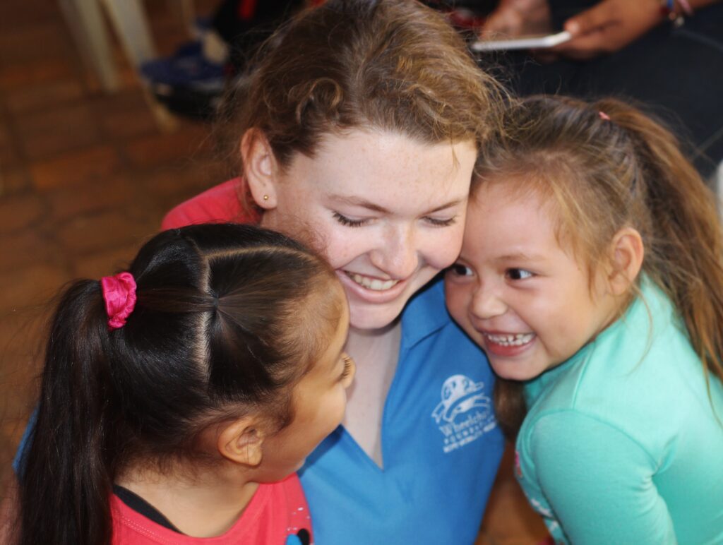 Lenberg with two young girls smiling