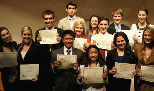 Group of people smiling with awards.