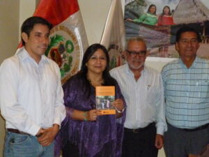Group of people smiling with book.