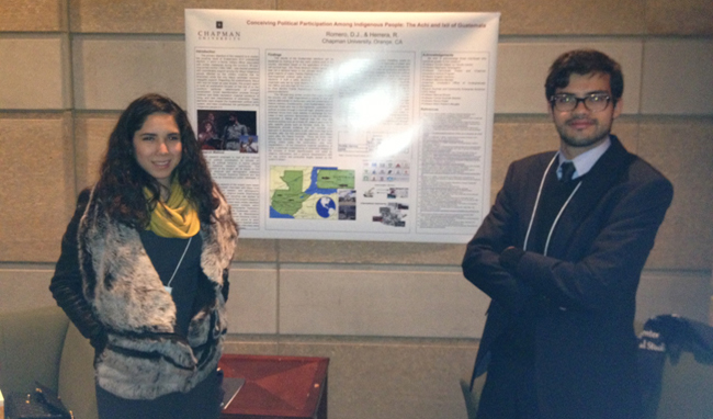 Woman and man smiling with presentation board.