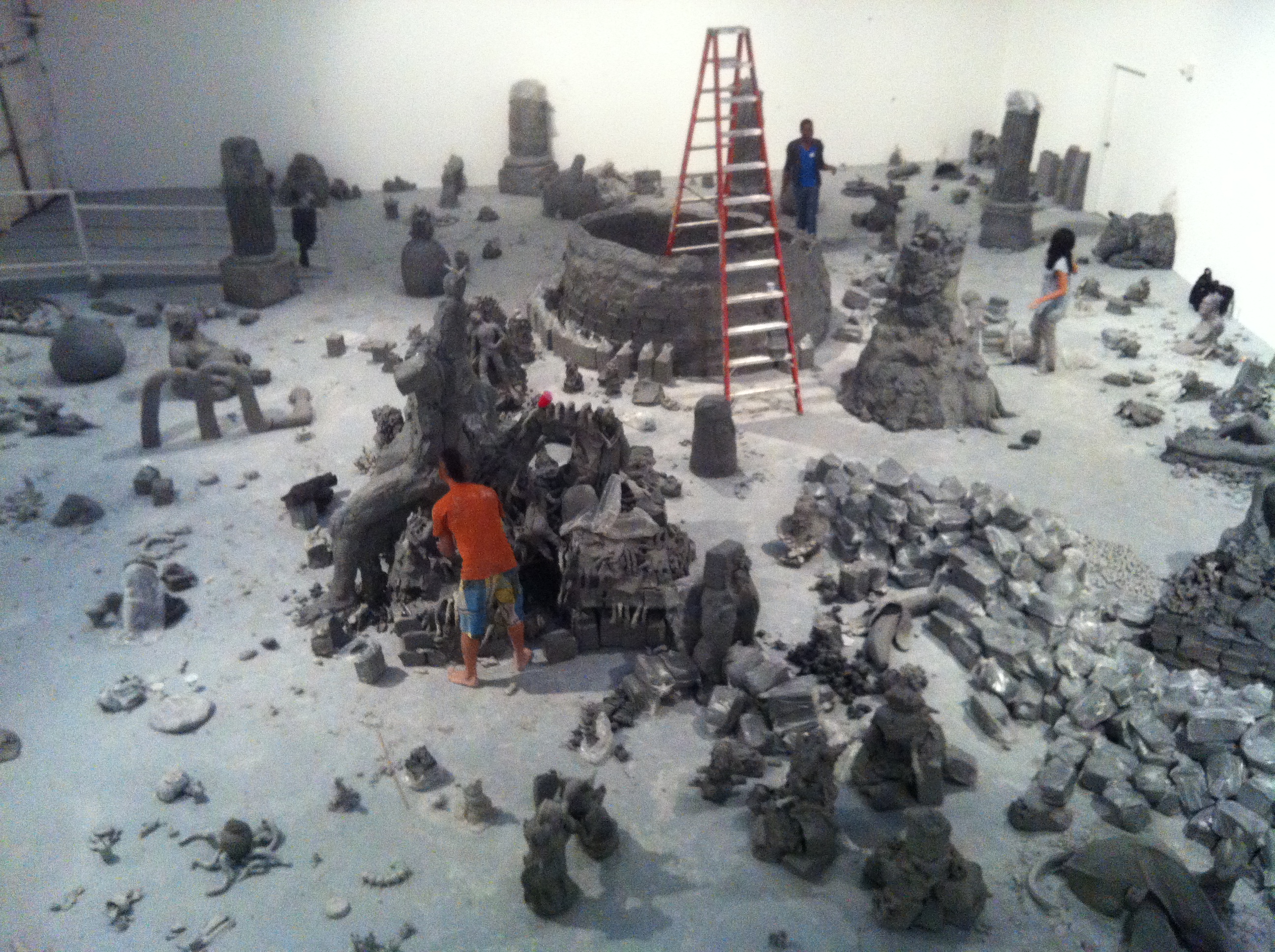 People working on clay sculptures.