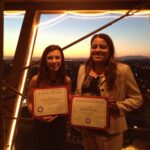 Two women with awards.