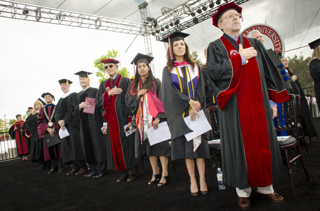 Group of people in regalia standing.